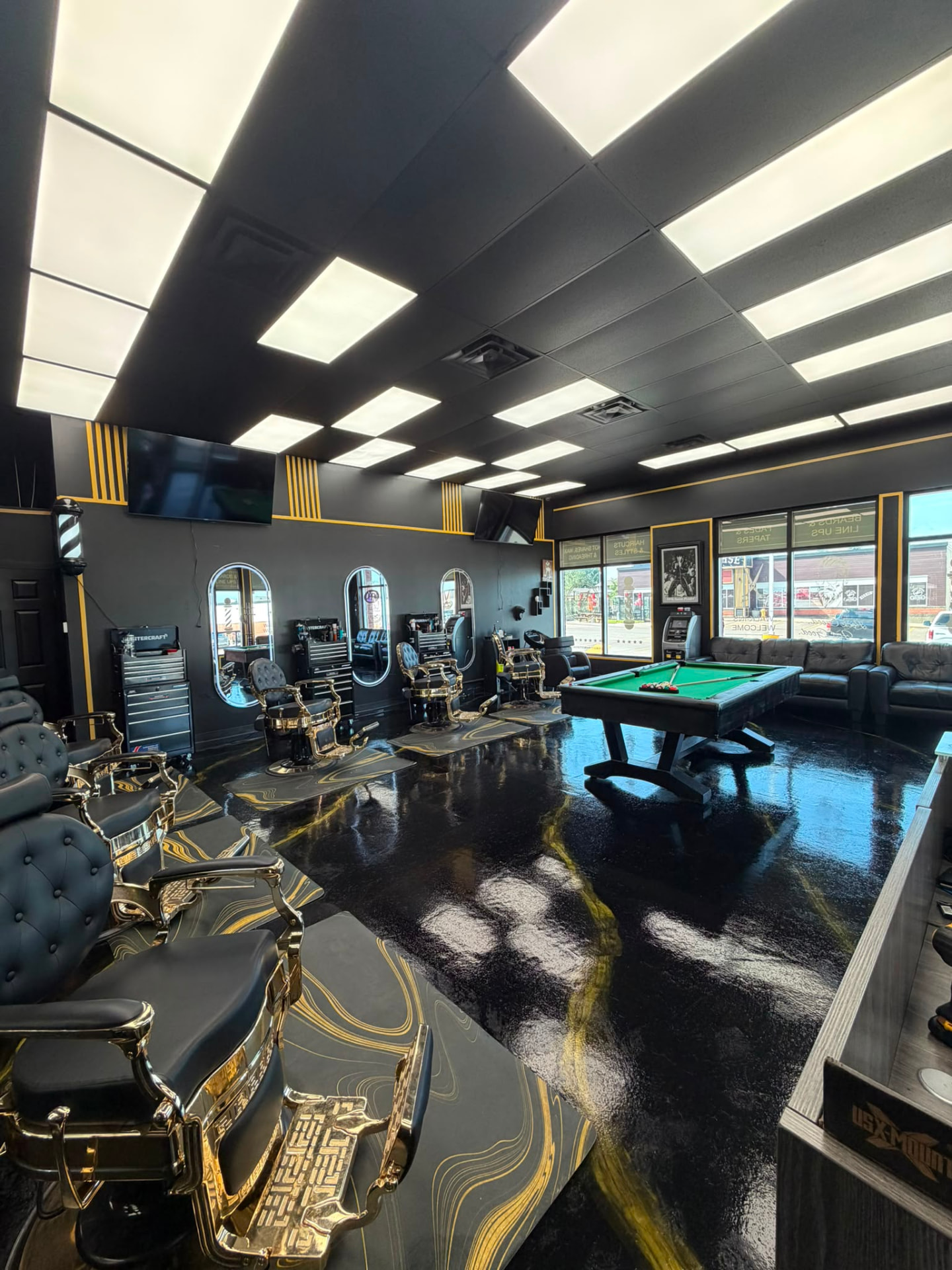 Inside A&J Barbershop — luxury barber chairs and warm lighting